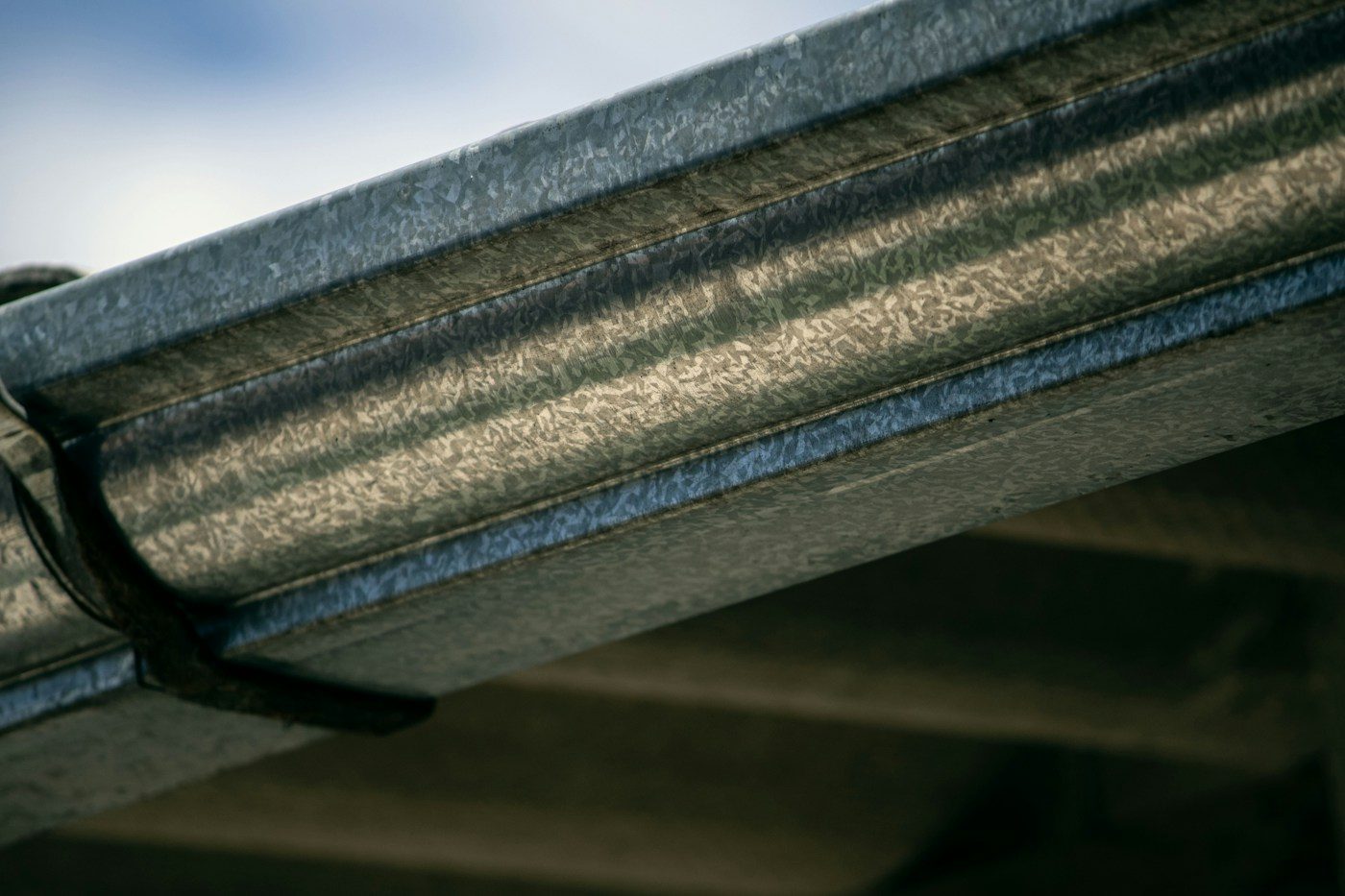 Close-up of a clean, newly installed metal gutter along a roofline